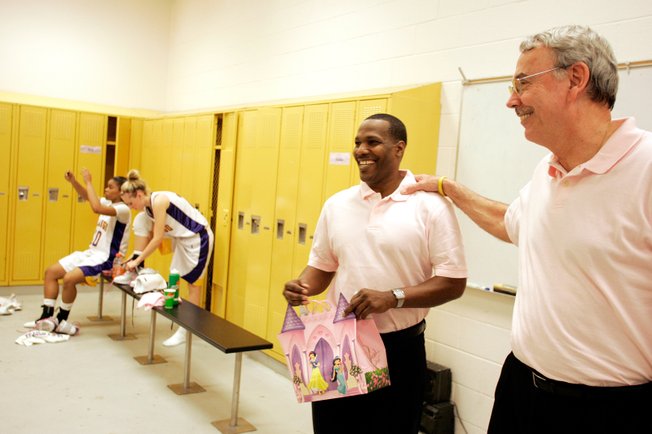 La Rocque, right, and assistant coach Al Valdez talk to their team after the game last month. La Rocque says he learned much of what he knows about coaching from legendary coach Lute Olson. 