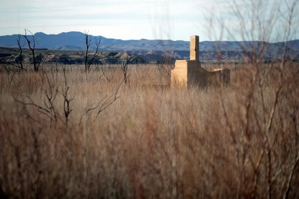 The remains of a building is seen through the tamarisk weeds that have grown over the site of the lost town of St. Thomas. The town was founded by Mormon settlers in 1865,  but was abandoned to the rising waters of Lake Mead in 1938.
