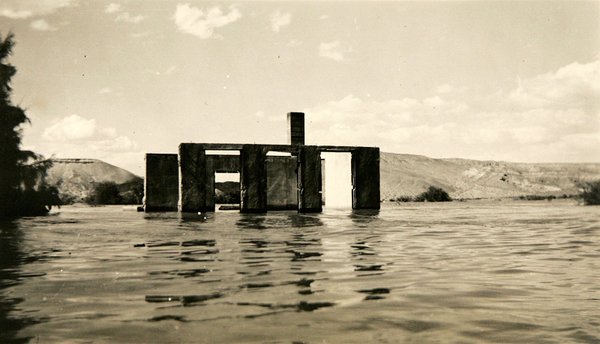 In this undated photograph, water rises over the ruins of ...