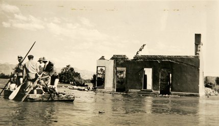An undated photograph shows a salvage party on a raft navigating the rising waters of Lake Mead.