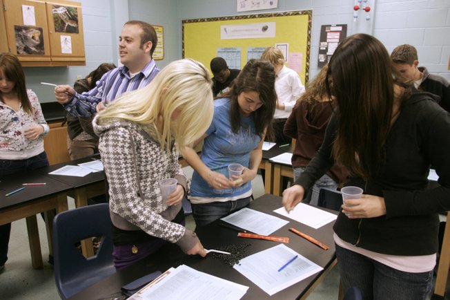 Coronado High School science teacher Brian Lenze monitors his lab students in honors biology class Tuesday. The lesson was Darwin’s principles of evolution.