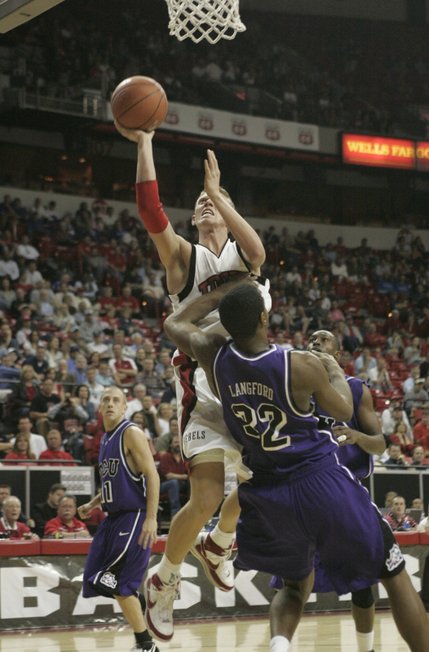 UNLV forward Joe Darger drives past TCU forward Kevin Langford during their game Thursday, March 13, 2008 at the Mountain West Conference championships.  