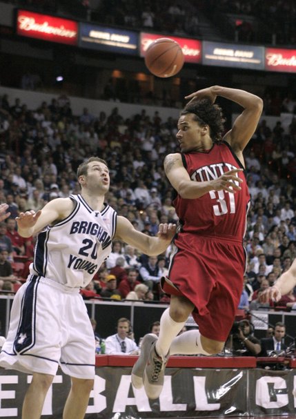 UNLV guard Curtis Terry passes behind his back over BYU guard Sam Burgess during their 76-61 defeat of BYU in the Mountain West Conference championship game Saturday, March 15, 2008 at the Thomas & Mack Center.