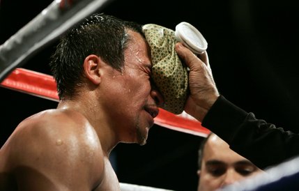 WBC super featherweight champion Juan Manuel Marquez is tended to in his corner during his title defense against Manny Pacquiao.