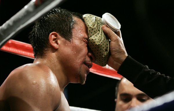 WBC super featherweight champion Juan Manuel Marquez is tended to ...