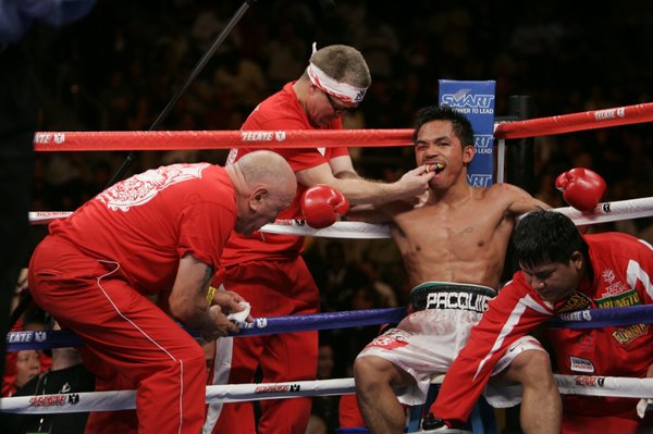 Manny Pacquiao is tended to between rounds during his fight ...