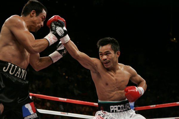 Manny Pacquiao, right, throws a punch at WBC super featherweight ...