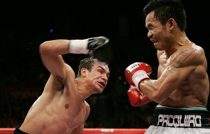 Manny Pacquiao prepares to take a hit from Juan Manuel Marquez during their fight Saturday.