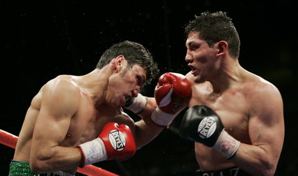 Ramon Montano, left, takes a punch to the face from David Diaz during their lightweight boxing match at the Mandalay Bay hotel.