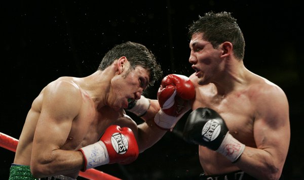 Ramon Montano, left, takes a punch to the face from ...