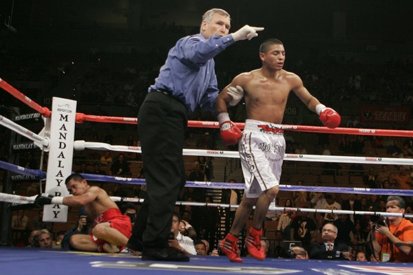 Referee Jay Nady, center, sends Abner Mares, right, of Mexico, ...