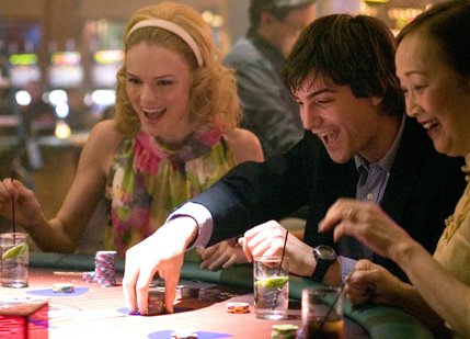 In Columbia Pictures' 21, when M.I.T. student Ben Campbell (Jim Sturgess, center) joins the blackjack team and takes Vegas for millions, he finds himself seduced by the money, the Vegas lifestyle, and his smart and sexy teammate, Jill Taylor (Kate Bosworth, left).
