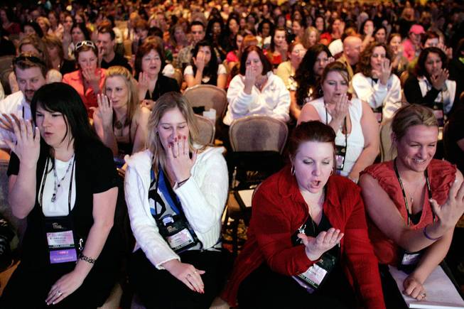 "Passion consultants" and their guests take part in a "mind over body" experiment during a convention Tuesday for Passion Parties, which sells intimacy products.