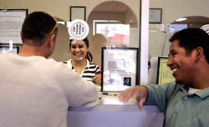 Teller Edith Gonzalez helps Ruben Rios, left, and Ruben Martinez wire money to Mexico at a money order store on Bonanza Road. Martinez, a construction worker, has seen his paycheck go from $2,800 a month to $600 a month, and he's sending less money home to Hidalgo.