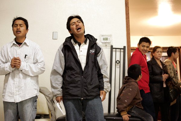 Porfirio Hernandez, from left, and Pascual Martinez sing a prayer ...