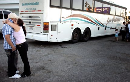Jose Pepe Hernandez gets a hug from a friend before boarding a bus bound for Mexico at Los Paisanos Bus Company. Hernandez is returning to Mexico to live because he cannot find work in residential construction. 
