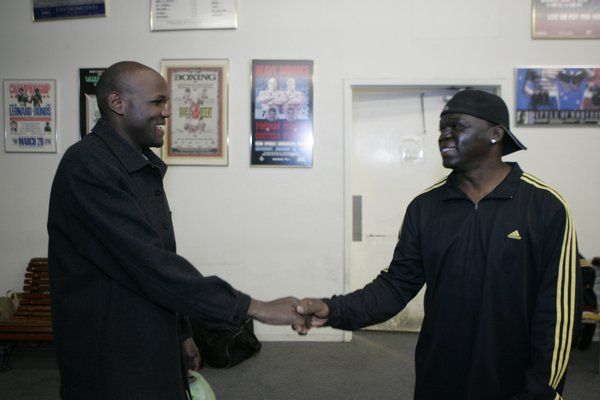 Joseph Kiwanuka, left, visits with trainer Jeff Mayweather during a ...