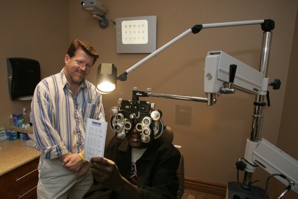 Brian Higginbotham, left, a technlogist at Silver State Eye Care, ...
