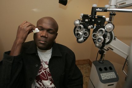 Joseph wipes his eyes in the examination room after having his vision tested at Silver State Eye Care.