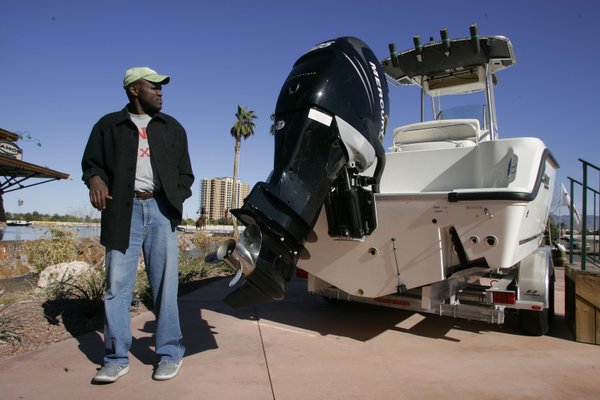Joseph takes a look at a boat engine at the ...