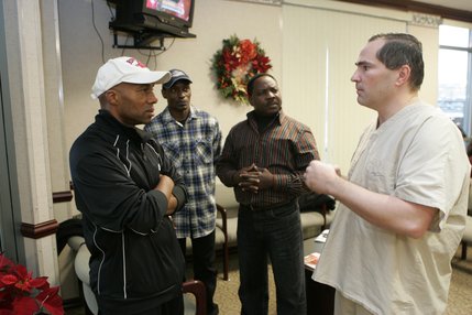 Dr. Thomas Kelly, right, updates Joseph's friends in the waiting room after cataract surgery on Kiwanuka's left eye at the Seven Hills Surgery Center in December. From left: UNLV assistant boxing coach Frank Slaughter, Geofrey Nsubuga Bwakamba and Francis Lutaaya. Lutaaya was Kiwanuka's boxing coach in Uganda and is now a pastor in Washington D.C. 