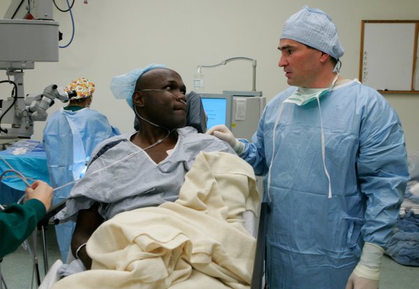 Joseph Kiwanuka listens to Dr. Thomas Kelly of Silver State ...