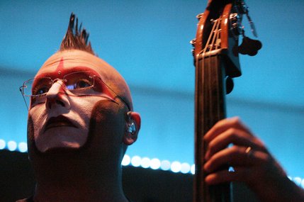 Derek Jones plays the bass live in a studio beneath the stage.