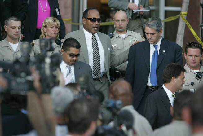 O.J. Simpson walks out of the Clark County Regional Justice Center Wednesday, April, 9, 2008,  after learning he and two co-defendants will go to trial on armed robbery and kidnapping charges.