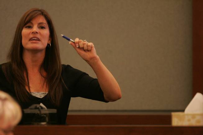 Eyewitness Melanie Nelson demonstrates during testimony how she observed Selimaj waving a knife in the air. 