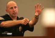 Henderson Police Officer Jeffrey Wiener, during testimony Thursday at the inquest at the Regional Justice Center, shows how he pointed his gun at Deshira Selimaj. Though Wiener did not fire at Selimaj, he said he nearly shot her because he thought she might harm her son.