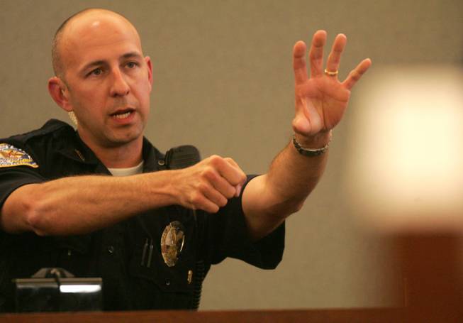 Henderson Police Officer Jeffrey Wiener, during testimony Thursday at the inquest at the Regional Justice Center, shows how he pointed his gun at Deshira Selimaj. Though Wiener did not fire at Selimaj, he said he nearly shot her because he thought she might harm her son.