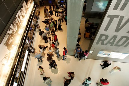 Visitors walk around the Internet, TV and Radio gallery during the opening day of the Newseum.