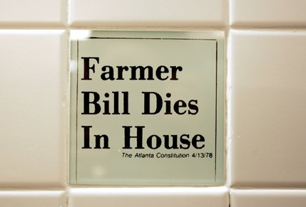 Tiles in the women's bathroom highlight headline bloopers from newspapers collected by the Columbia Journalism Review.