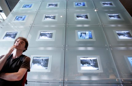 Mark Hillier of London, England looks at a display during the opening day of the Newseum. 
