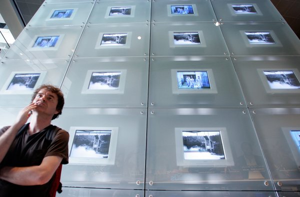 Mark Hillier of London, England looks at a display during ...