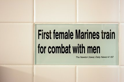Tiles in the women's bathroom highlight headline bloopers from newspapers collected by the Columbia Journalism Review.