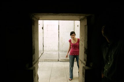 Katherine Kipp of Jackson, Tenn. looks into one of the exhibits--the ground floor doorway of a three-story East German guard tower that was located near Checkpoint Charlie in East Berlin.