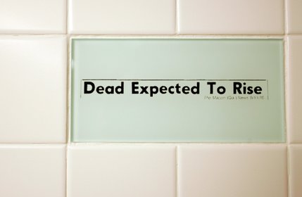 Tiles in the women's bathroom highlight headline bloopers from newspapers collected by the Columbia Journalism Review.