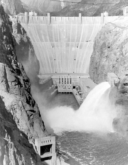 Water erupts out of the spillways of the Hoover Dam in this photo taken during the 1930's. The seventeen turbine-generators housed inside the dam are capable of producing up to 2,080 megawatts of electricity. This is enough energy to supply Nevada, Arizona and most of California.