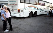 Jose Pepe Hernandez gets a hug before boarding a bus bound for Mexico. He is going back because he can no longer find work in residential construction in Las Vegas. The effect on Nevada's economy of the departure of many immigrant workers has taken officials by surprise.