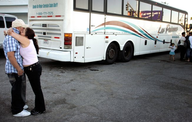 Jose Pepe Hernandez gets a hug before boarding a bus bound for Mexico. He is going back because he can no longer find work in residential construction in Las Vegas. The effect on Nevada's economy of the departure of many immigrant workers has taken officials by surprise.