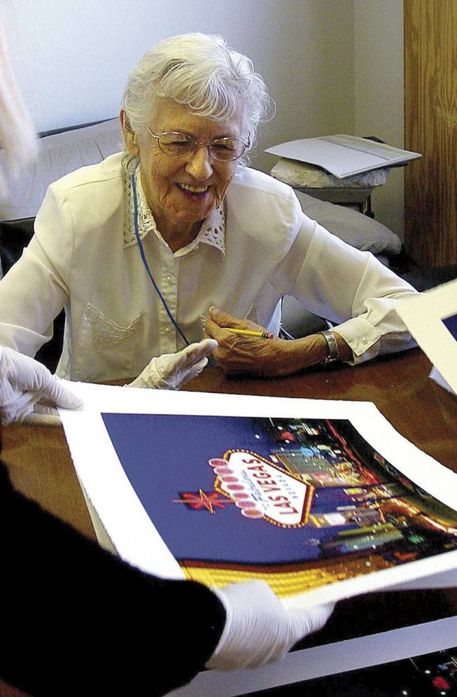 Betty Willis autographs prints of the iconic "Welcome to Las Vegas" sign last week at a local art gallery. She refers to her creation as "the little sign that could," and keeps three replicas at home.