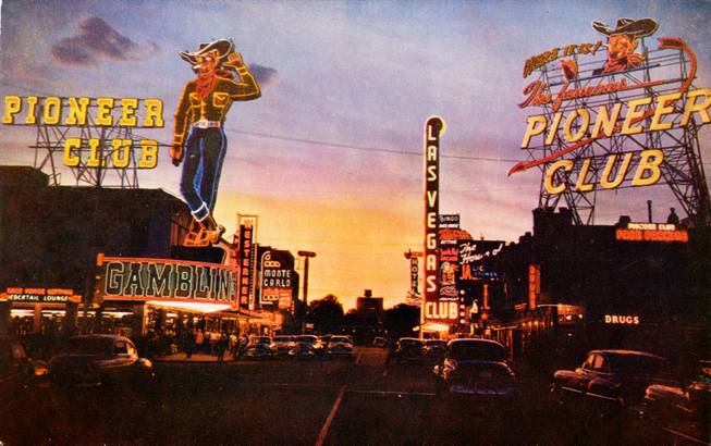 The sun sets on the western themed Pioneer Club in this 1950s postcard. The casino utilized the roof of an adjacent property to advertise its location with the help of the extra large "Vegas Vic" .  Of all the neon signs in the photograph, "Vic" is the only one that remains in use today.