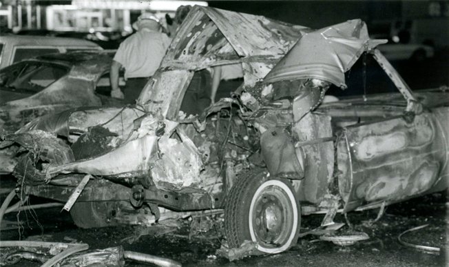 Investigators examine the area surrounding the twisted remnants of Frank "Lefty" Rosenthal's car after a bomb destroyed the vehicle on Oct. 4, 1982. A metal plate directly underneath the driver's seat of the Cadillac diverted the explosion away from Rosenthal, saving his life. 
