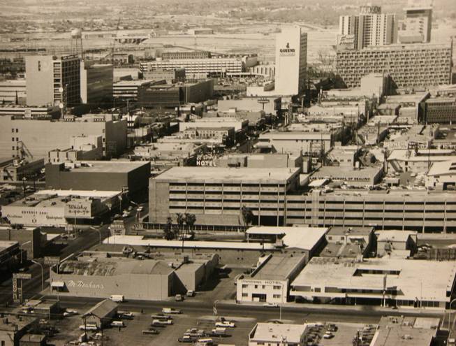 An aerial photo looking west towards downtown Las Vegas shows Fremont Street circa 1974. The street was closed to vehicular traffic in 1994 and covered by the 1,500-feet electronic-screen canopy of the Freemont Street Experience.