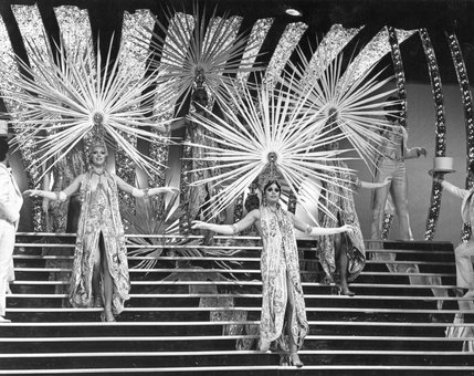 Showgirls don elaborate headpieces in a 1978 stage production. Showgirls first appeared in Las Vegas during the 1950s at the Dunes, Sands and Desert Inn -- but it wasn't until the 1960s and 70s that they became a cultural icon.