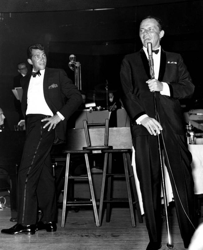 Dean Martin looks on as Frank Sinatra sings a number during one of the Rat Pack's performances at the Sands' Copa Room. After Sinatra left the Sands, Martin continued to play at the Copa Room by himself, until becoming a longtime headliner at the MGM Grand.
