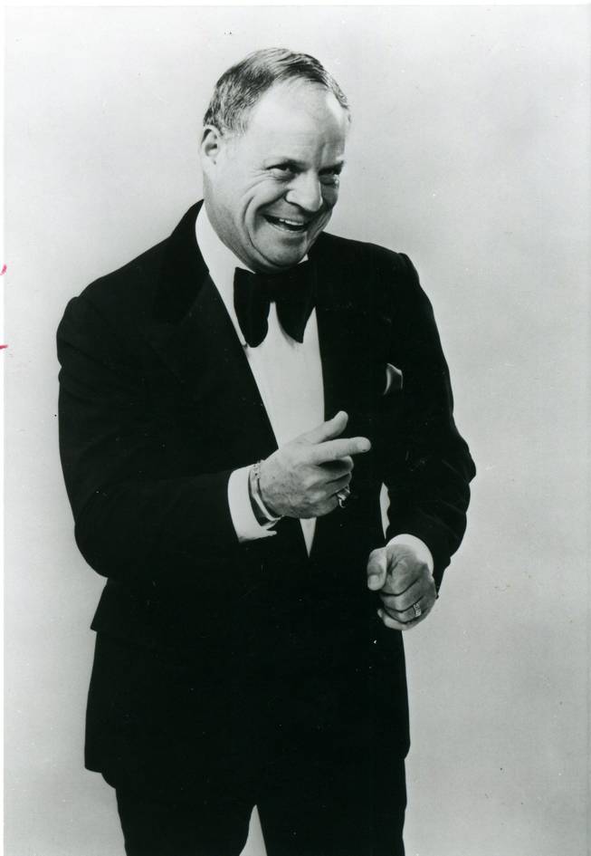 Comedian Don Rickles points and smiles during a promotional photo shoot. His witty brand of insult comedy earned the admiration of Frank Sinatra, who nicknamed the comedian "bullet head."