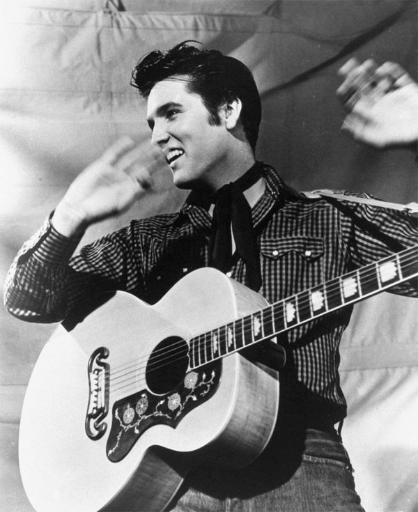 Elvis Presley is shown with his Gibson J-200 guitar in ...
