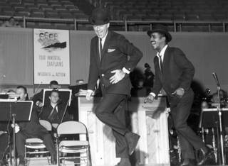 Rat Pack members Peter Lawford and Sammy Davis Jr. do a number together for a performance that occurred sometime during the 1960s. The duo collaborated numerous times, most notably co-producing and co-starring in the movies 